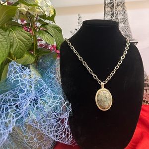 silver tone necklace with green amethyst stone medallion